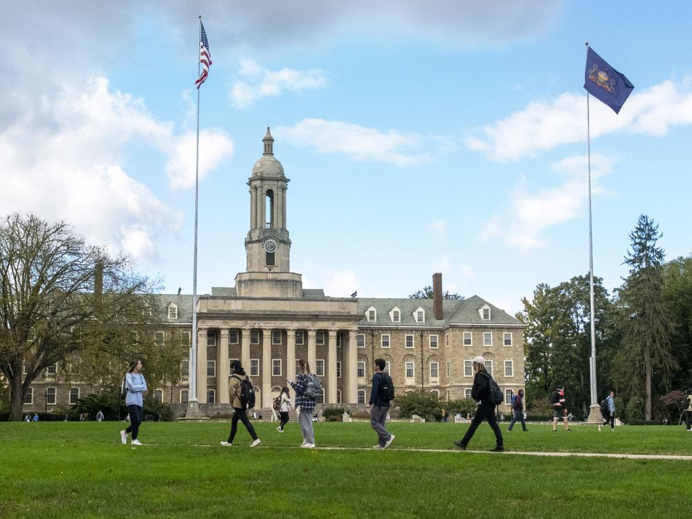 students walking in front of Old Main